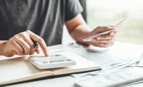 Private Mortgage Insurance (PMI) Explained: A Guide for Homebuyers. Man using calculator Accounting Calculating Cost Economic bills with money stack step growing growth saving money in home , finance concept